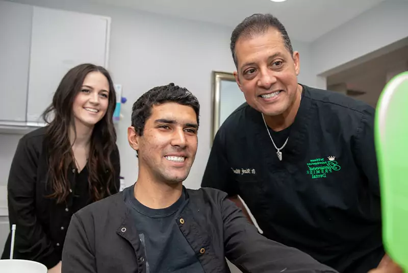 above.jpg Patient John looking into the mirror and smiling after full-mouth reconstruction with root canals and dental crowns to save severely decayed teeth.